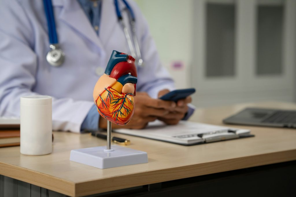 A male doctor sits at a desk in heart clinic, consulting onlinegiving advice.The vascular surgery